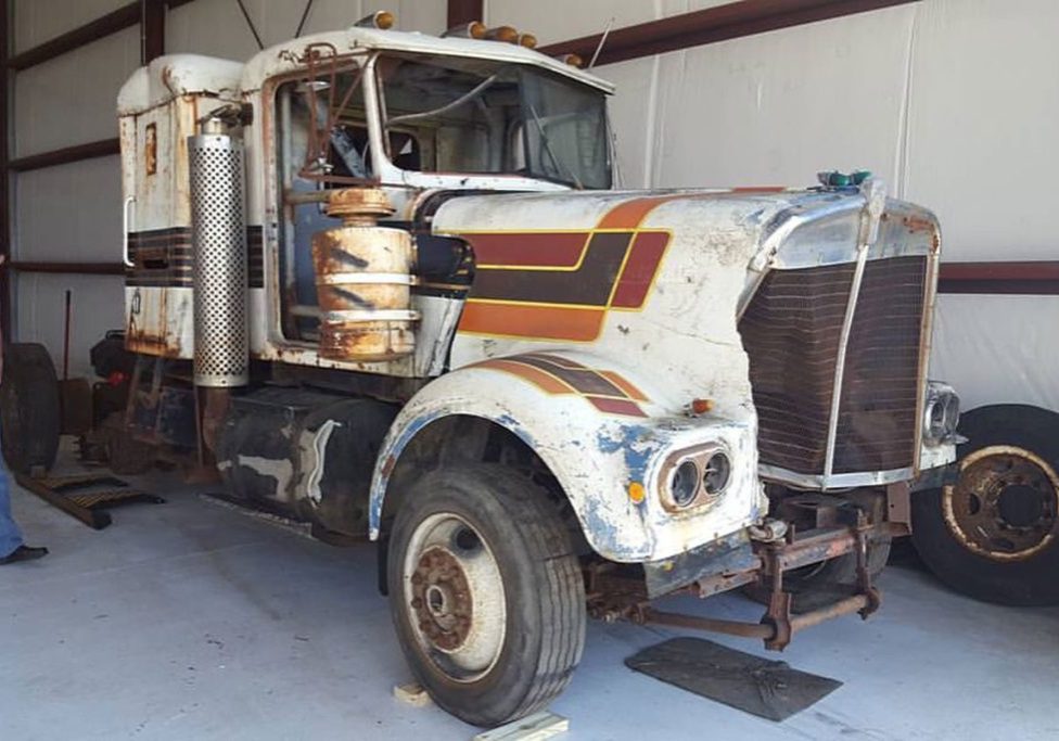 Damaged white semi truck in warehouse